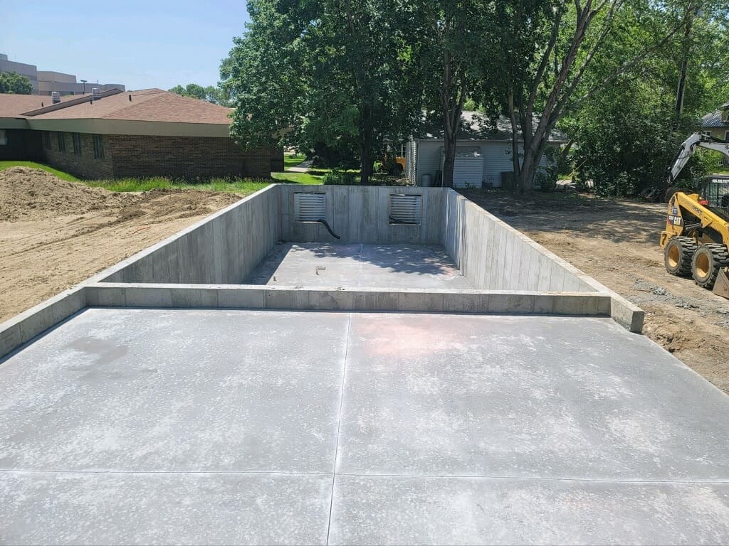 Poured foundation walls and a fresh garage pad