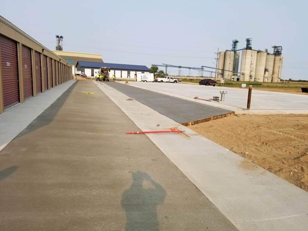 A fresh apron and walk going down at the storage units by the grain elevator