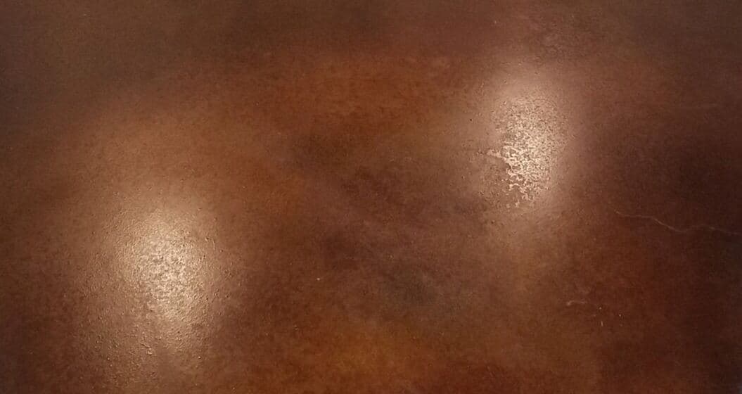 An acid stained concrete floor finished in warm brown, by Top Grade