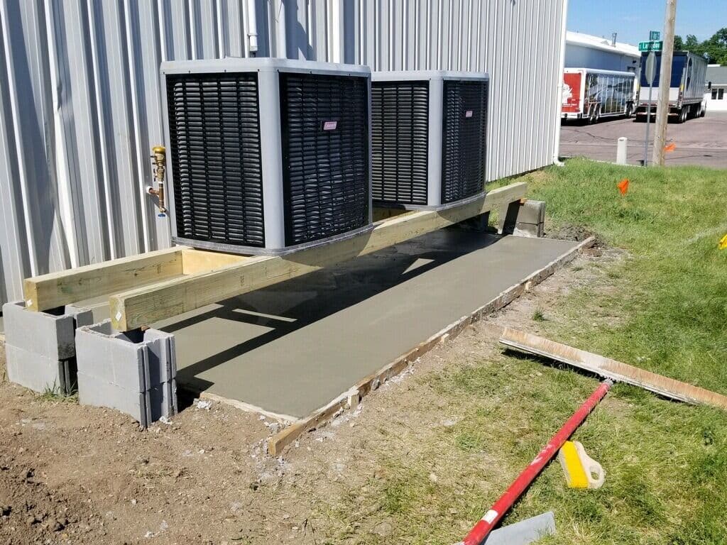 Fresh equipment pads poured under the condensers at a commercial building