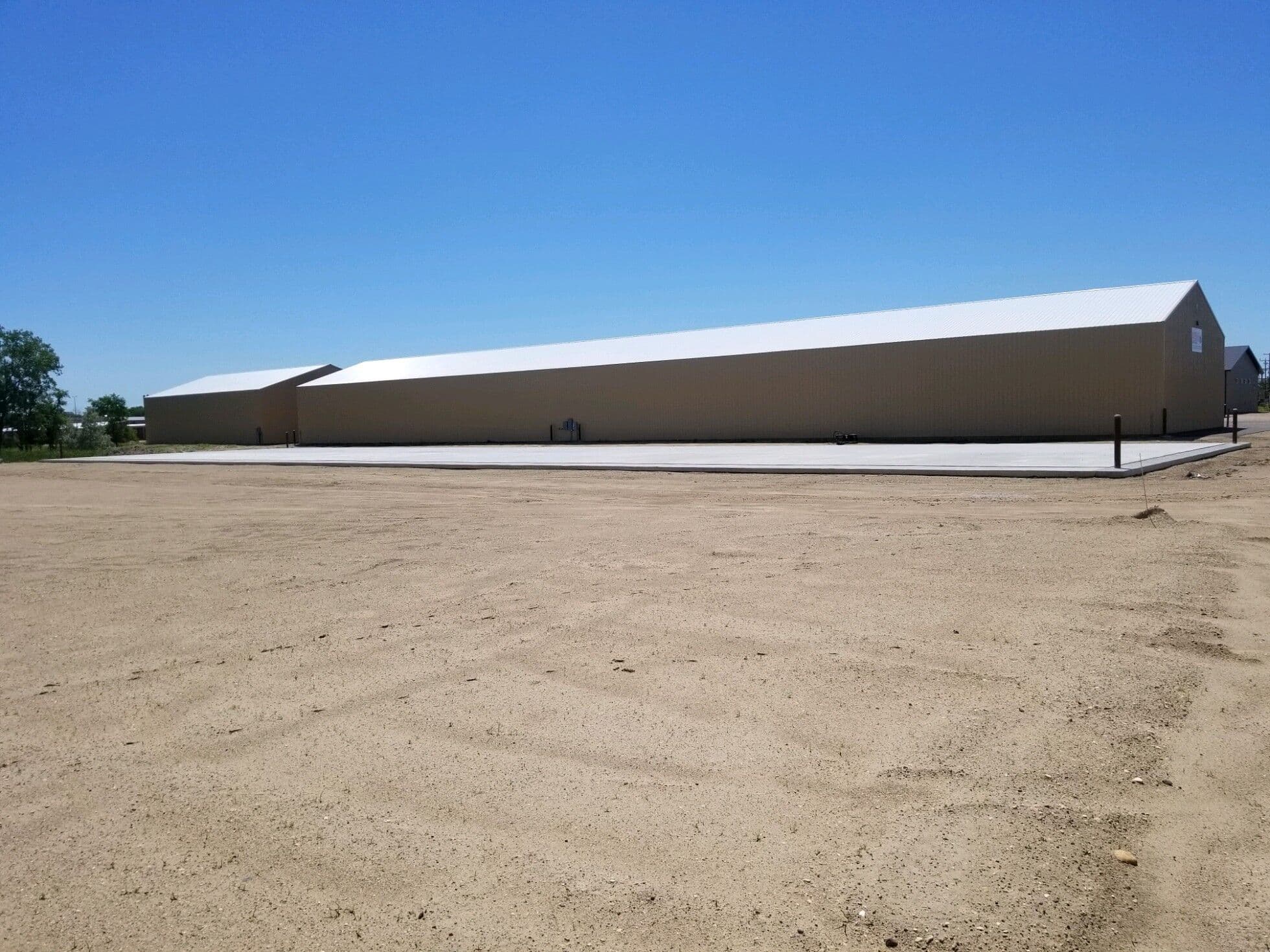 A long concrete pad poured the full length of a new agricultural building
