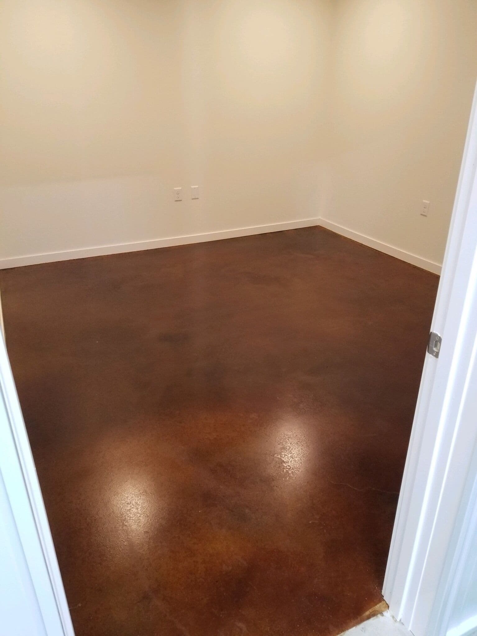 An acid stained concrete floor finished in warm brown