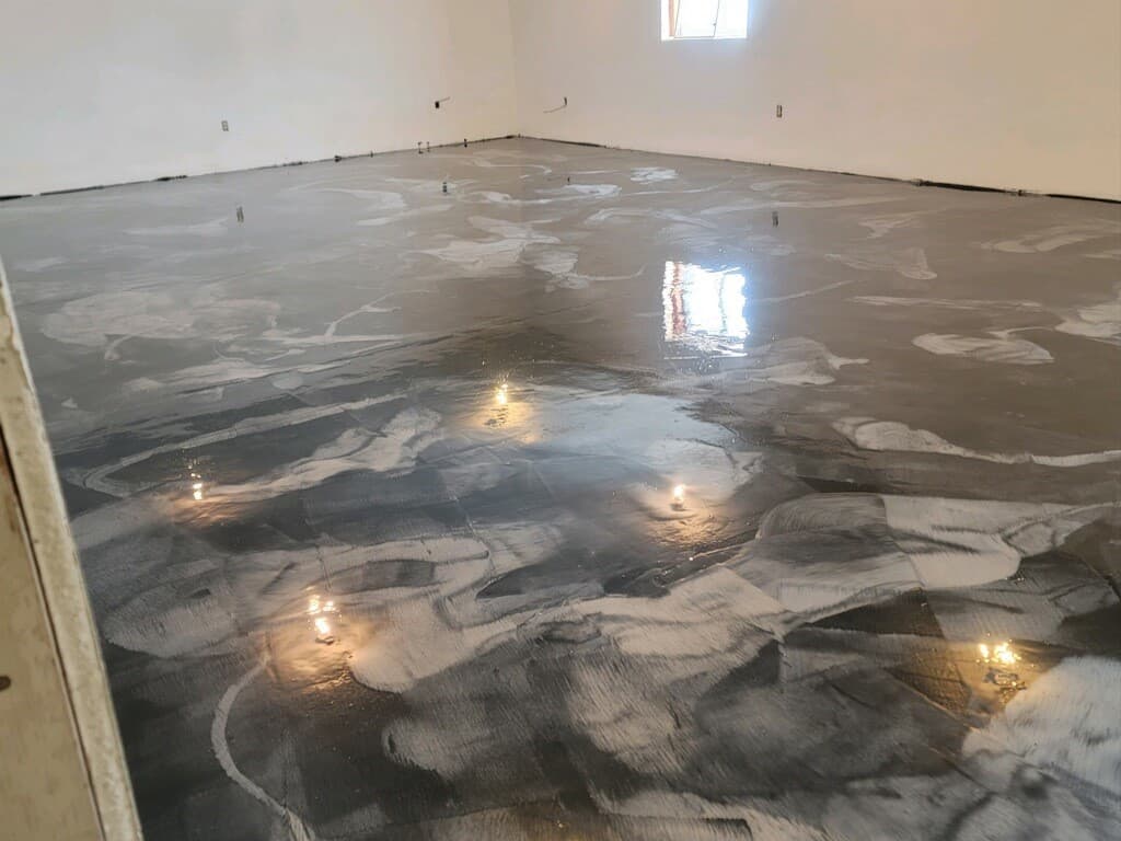 A metallic epoxy floor finished in a silver marble effect